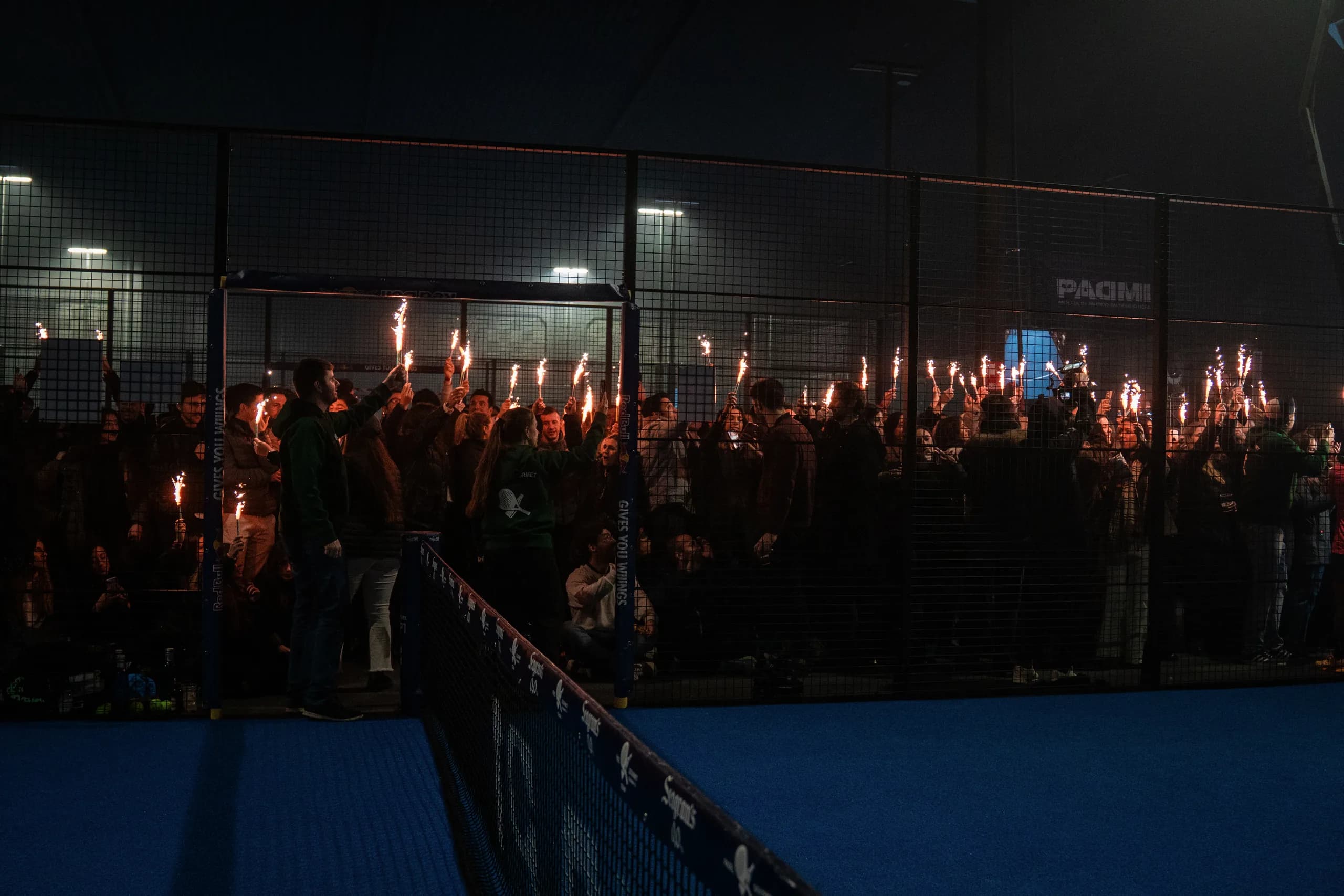 público con bengalas junto a la pista al final del torneo
